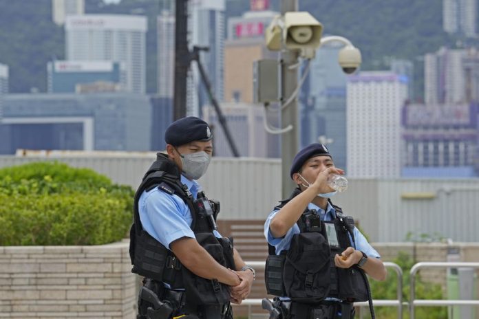 Police officers patrol outside the high speed train station for the Chinese president Xi Jinping's visit to mark the 25th anniversary of Hong Kong handover to China, in Hong Kong, Thursday, June 30, 2022. (AP Photo/Kin Cheung)